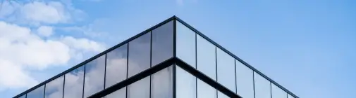 Modern glass office building with reflective windows and clean lines
