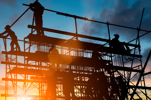 A group of construction workers at sunset