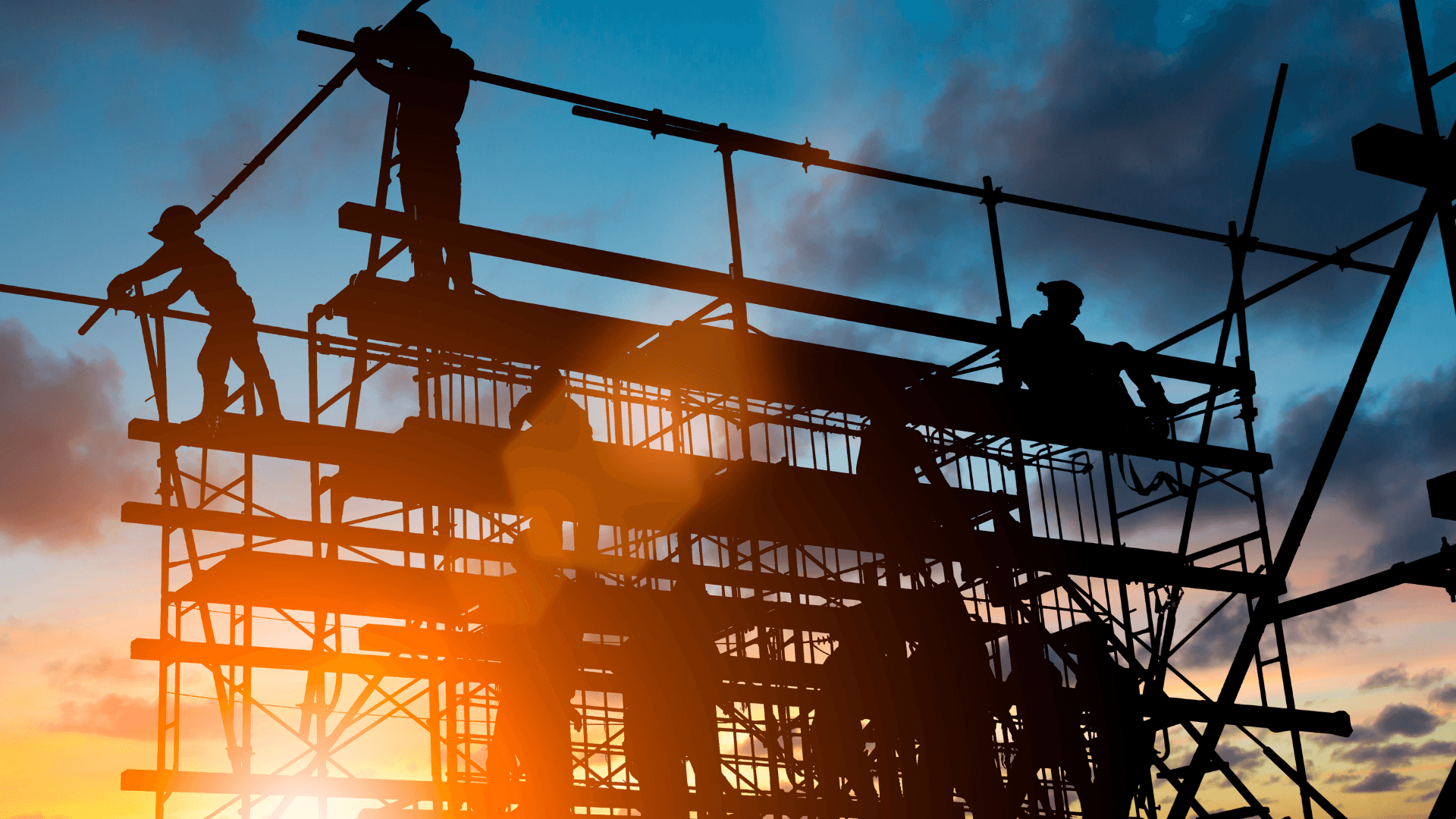 A group of construction workers at sunset