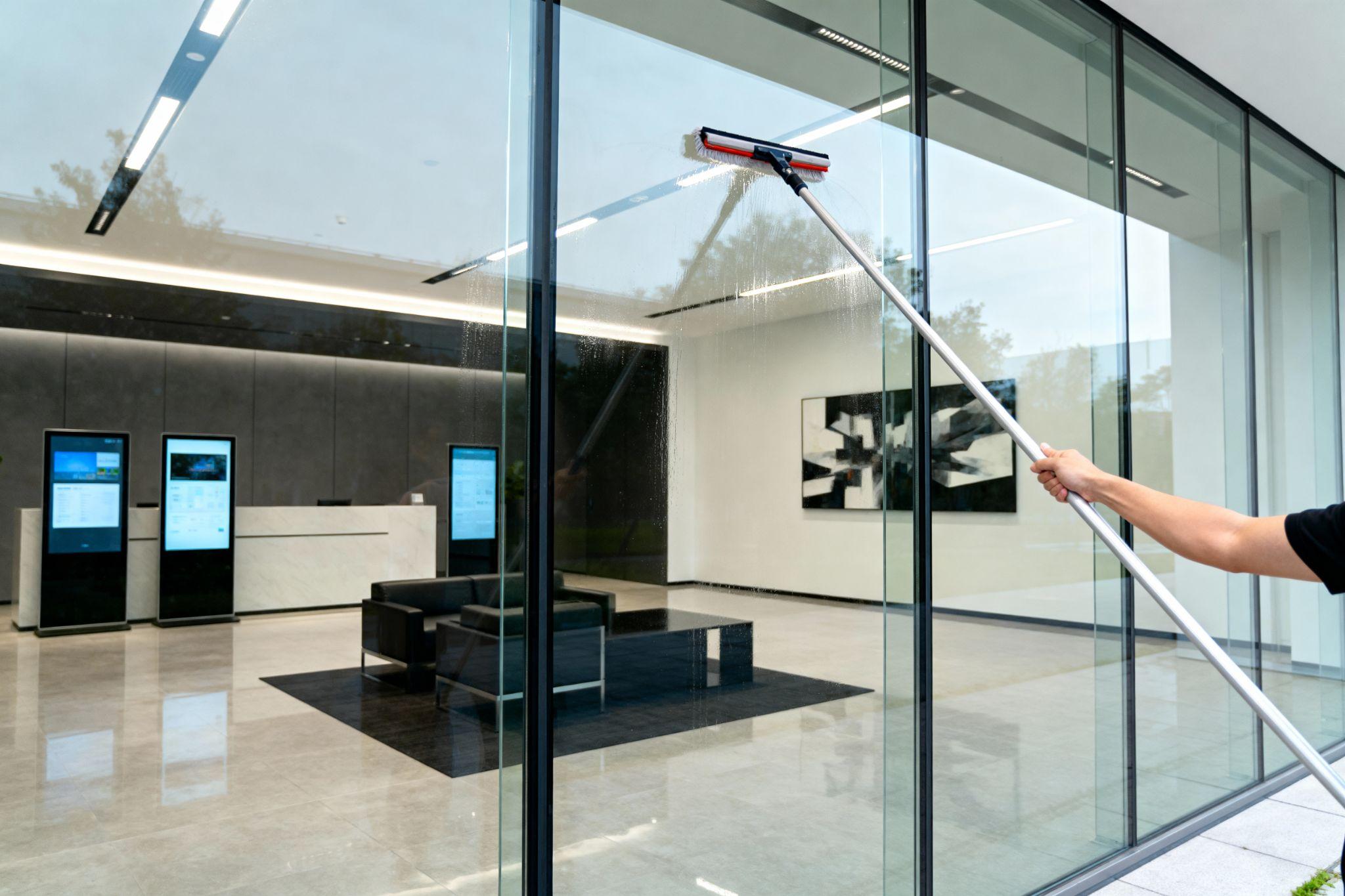 Professional window cleaning at a modern commercial office lobby